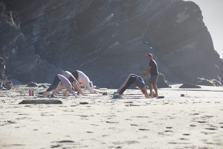 downward dog on beach during yoga retreat